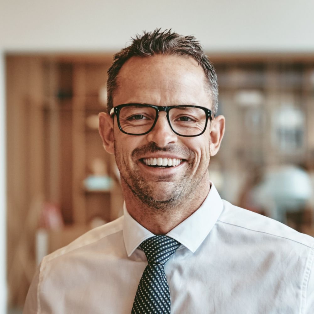 Testimonials smiling mature businessman standing alone in an of y89vgbd 1 1.jpg